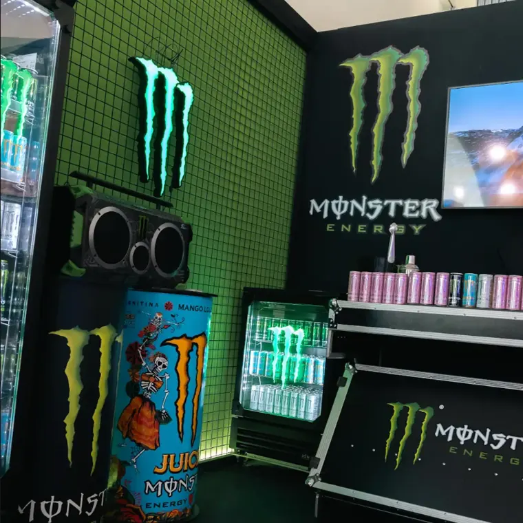 Monster Energy stand with a branded fridge and speakers